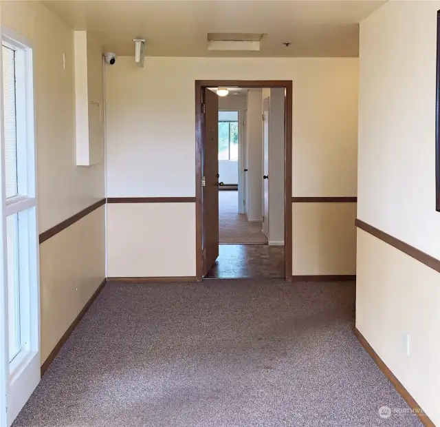 Entry door to the unit with peephole and security deadbolt lock. Entry interior with Jeron®-brand communication intercom for visitor entry access. Faux-tile vinyl floor. Entry coat closet.