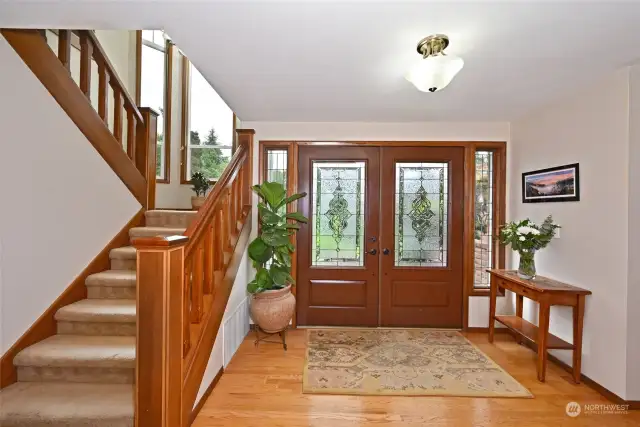 Enter through a large foyer featuring French doors and an open staircase.