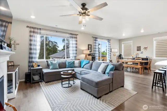 The wide open living space with gorgeous hardwood/laminate floors & high ceilings with walls of windows is light and bright and airy.