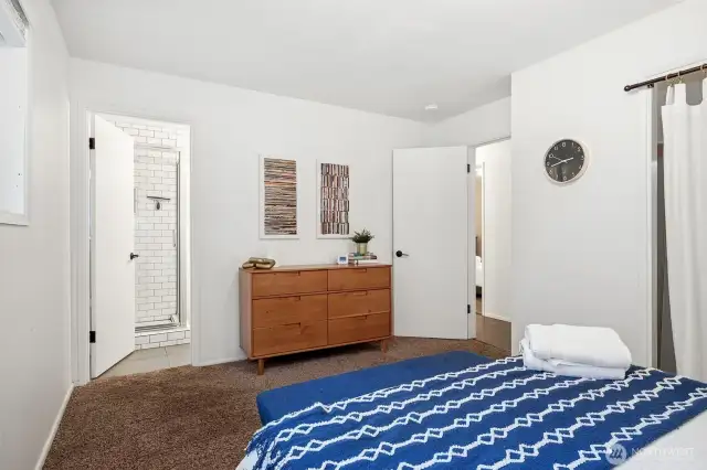 This primary suite nails it with contemporary white walls, a spacious closet, and direct access to the attached bathroom. It’s about simple elegance that maximizes every inch of the space.