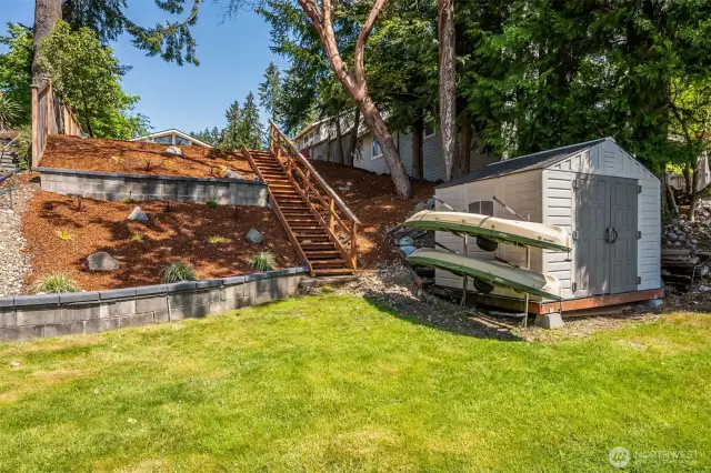 Get organized with the shed and kayak rack—perfect for storing all your outdoor gear for endless fun on Long Lake. The staircase, framed by terraced landscaping beds, leads you down to the water’s edge, where you can plant your dream garden and enjoy year-round outdoor living. Long Lake, located in Thurston County, is known for its peaceful waters and stunning natural beauty—ideal for boating, fishing, or simply soaking up the view.