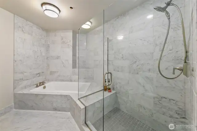 marble bath- tub and large frameless glass shower