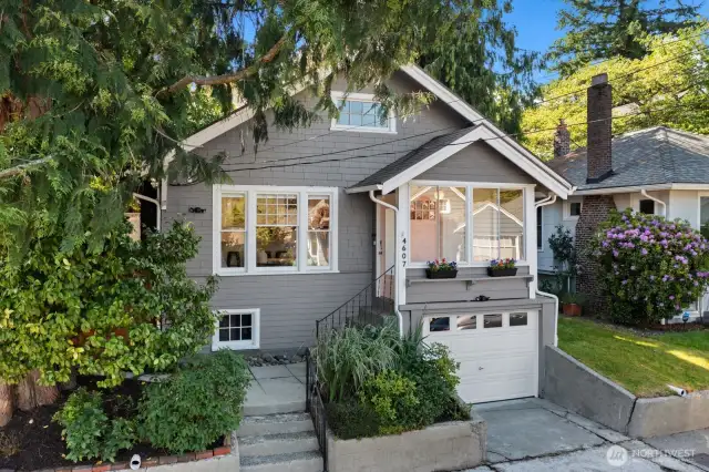 This adorable craftsman bungalow sits up from the street and is full of charm!