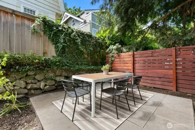 Out back is this beautiful patio in the fully fenced in and pet-friendly backyard.