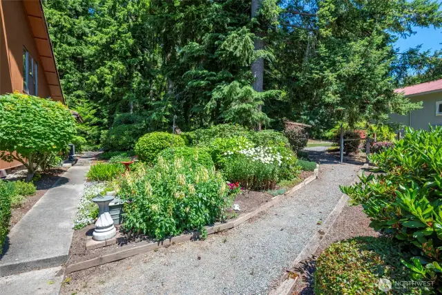 Well nurtured gardens and paths leading to the shop