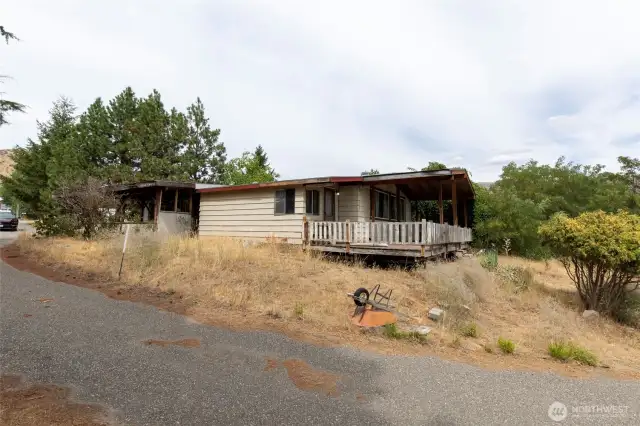 side showing carport and deck