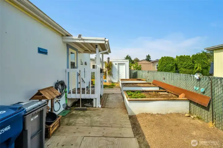 Raised flower beds in the fenced backyard.