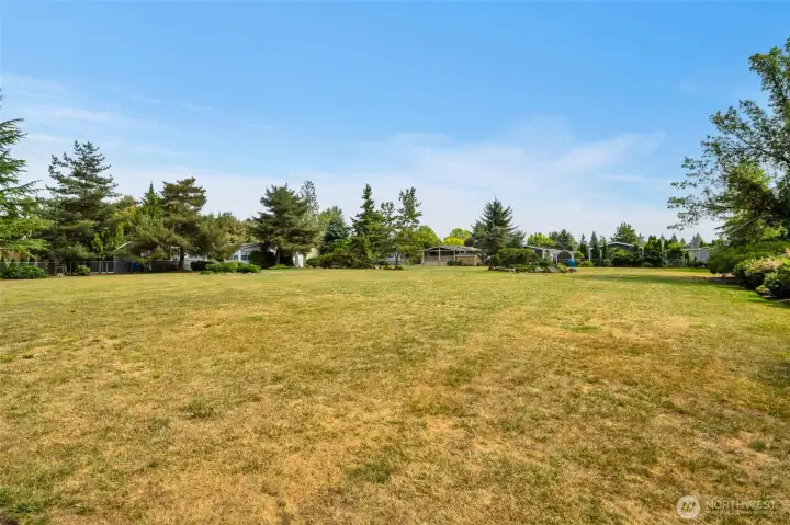 Open field common area is next to the office and across from this home.