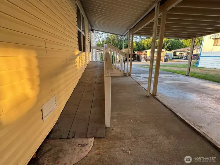 Nice covered parking to a ramp to the front door.