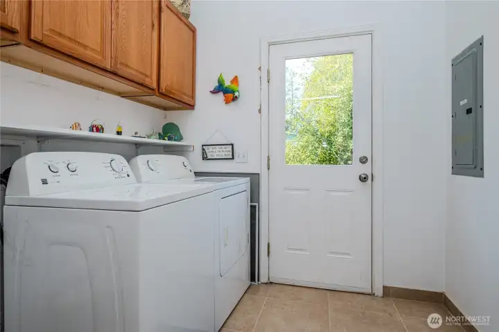 Laundy room has a back door entrance to the yard.