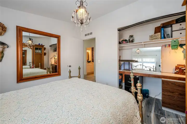 Closet has a computer desk workstation.