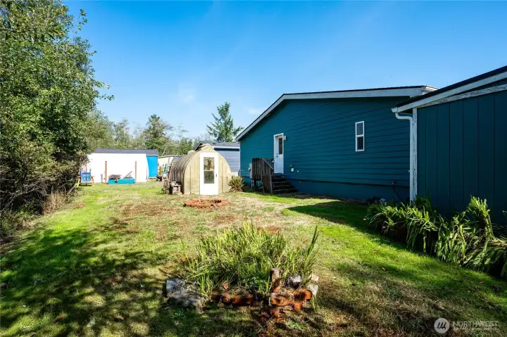 The large back yard also has a green house.