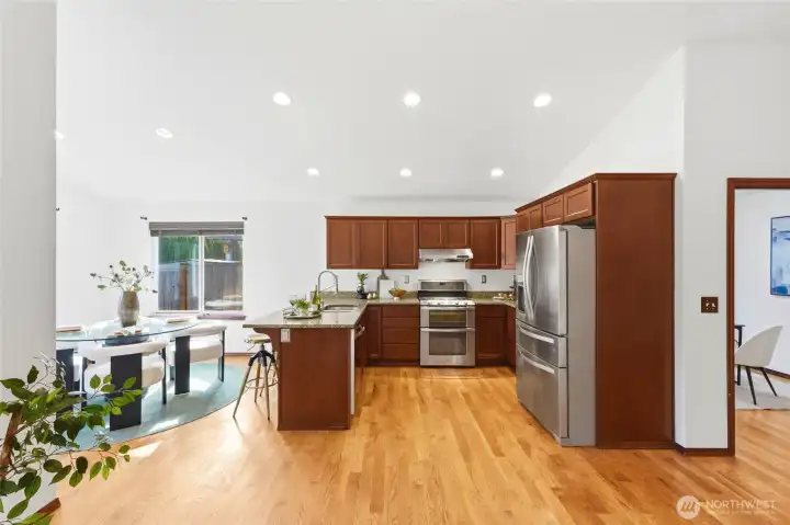 Open-concept kitchen with generous cabinetry, stainless appliances, and a seamless connection to the dining space.