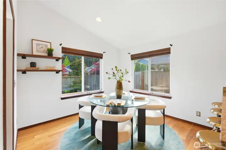 Light-filled dining space with windows all around and easy access to the covered deck.