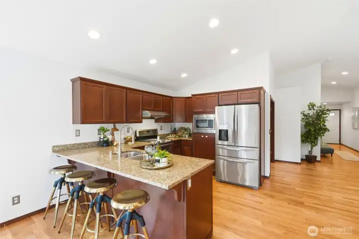 Spacious kitchen island with bar seating, offering a comfortable spot for casual meals and gathering.