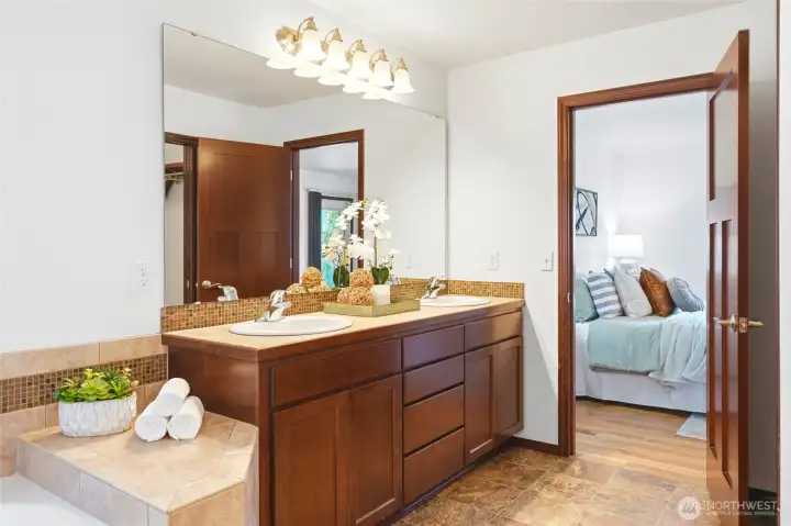 Primary bathroom with double vanity, ample storage, and a clean, functional layout.
