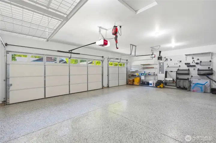 Spacious 3-car garage with durable epoxy floors and plenty of room for vehicles, storage, or projects.