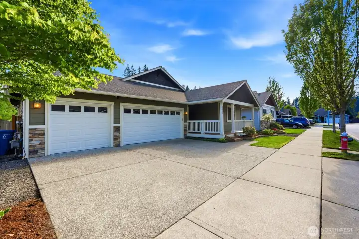 Large driveway provides plenty of parking and space to spread out, all set along clean sidewalks in a well-maintained neighborhood.
