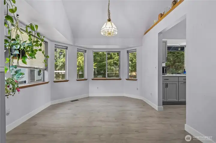 Breakfast Nook / Dining Room off the Living and Kitchen offers a gorgeous view of the lush backyard.