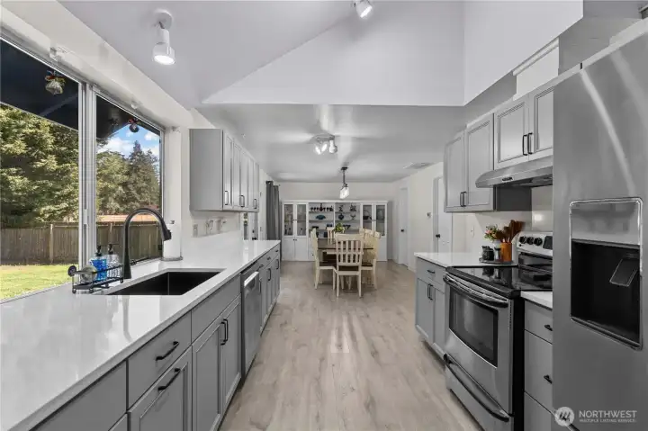 Kitchen w/New Cabinets, Quartz Counters, Stainless Steel Appliances and Laminate Floors.