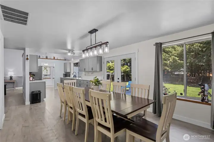 Dining Room / Family Room off the Kitchen w/Double Doors to a brand-new concrete patio.