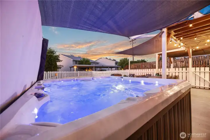 Twilight view of private hot tub and outdoor living area. Twilight view of private hot tub and outdoor living area.