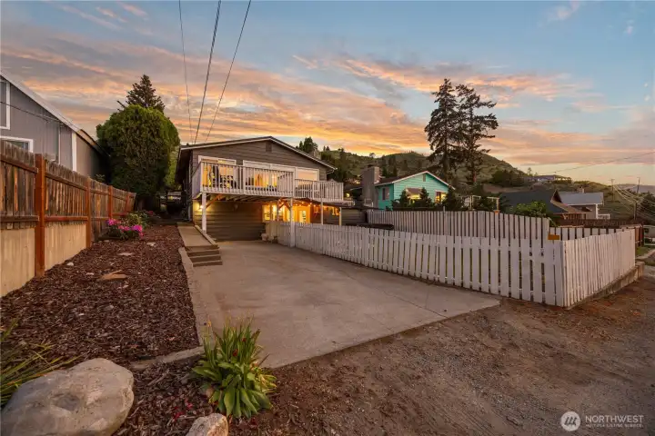Exterior twilight view of home with landscaping, driveway and fenced yard. Exterior twilight view of home with landscaping, driveway and fenced yard.