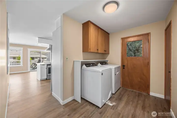 View of main level hallway and utility room. View of main level hallway and utility room.