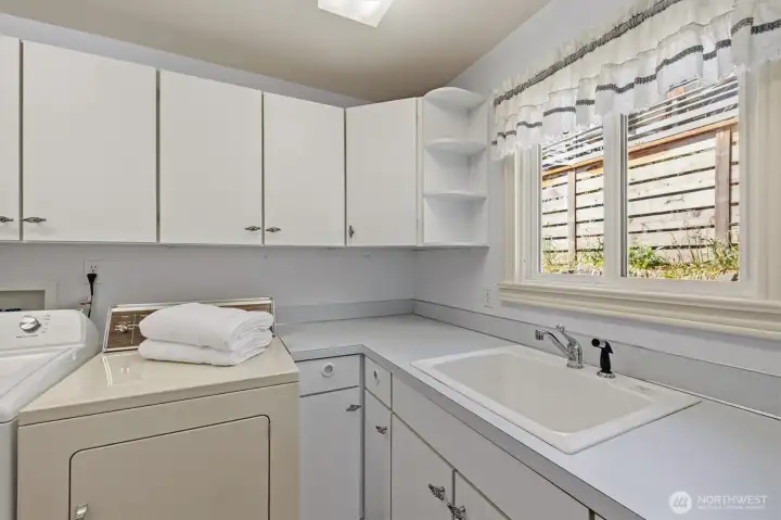 Laundry room leads to back yard.