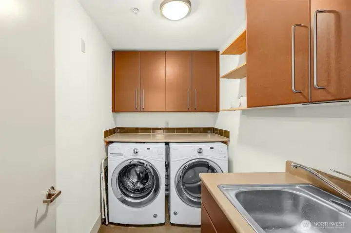 Laundry room with full size Washer and Dryer, utilty sink.