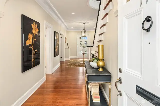 Entry hall with period details, grand staircase and walls perfect for displaying art.