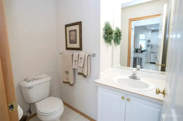 Powder room off of kitchen and laundry room