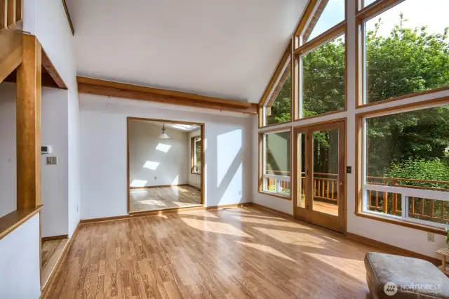 Living room opens to the dining space and deck.