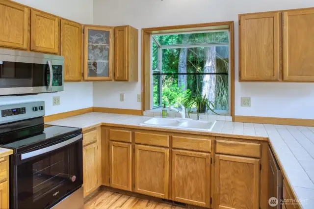 Kitchen looks towards the forest.