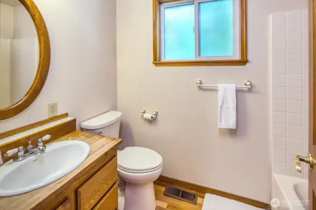 Main floor 3/4 bathroom with new toilet and newly refinished hardwoods.