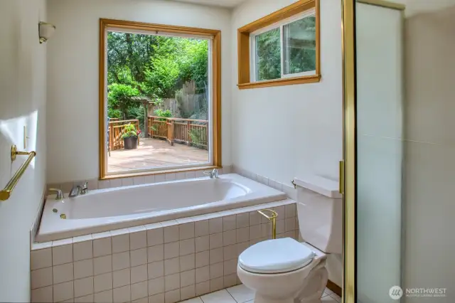 Primary suite bathroom overlooks the deck.
