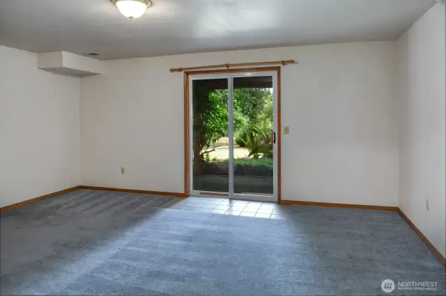 Lower level bedroom with slider to garden.