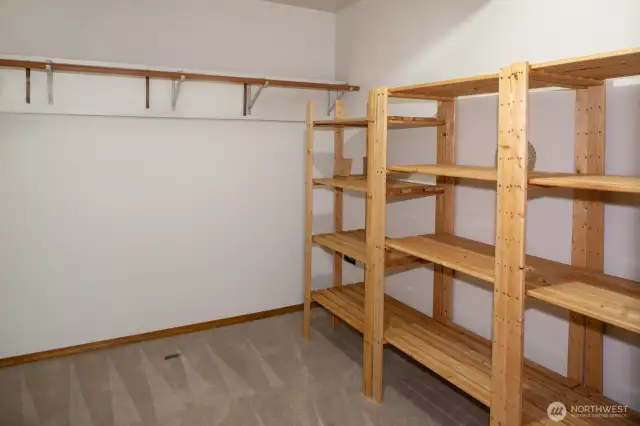 Walk in closet with the lower bedroom suite.
