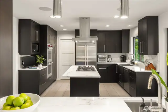 Gourmet kitchen is a chef's delight, featuring stainless Wolf & Subzero appliances, double wall ovens and marble countertops