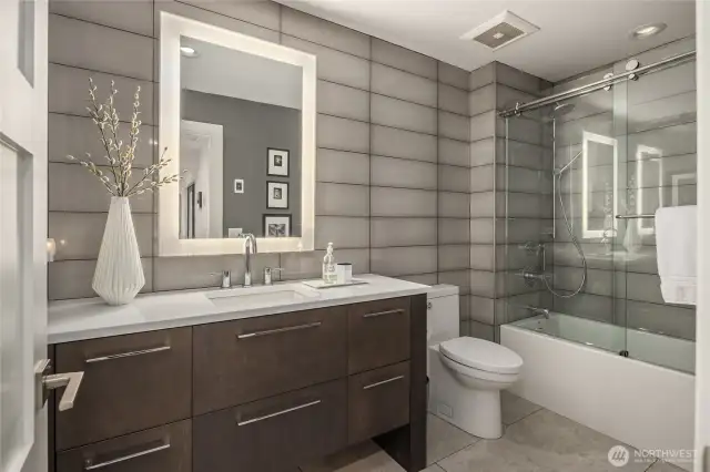 Powder room has a full shower/tub and heated tile floors