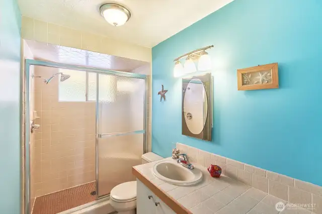 Bathroom with tiled shower.