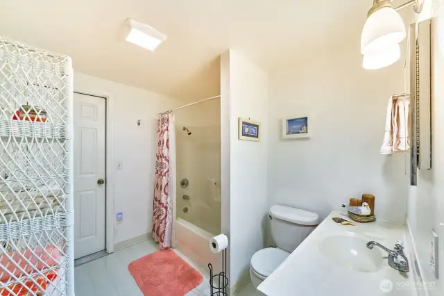 Full bathroom leads to garage, an easy way to clean up before entering the house