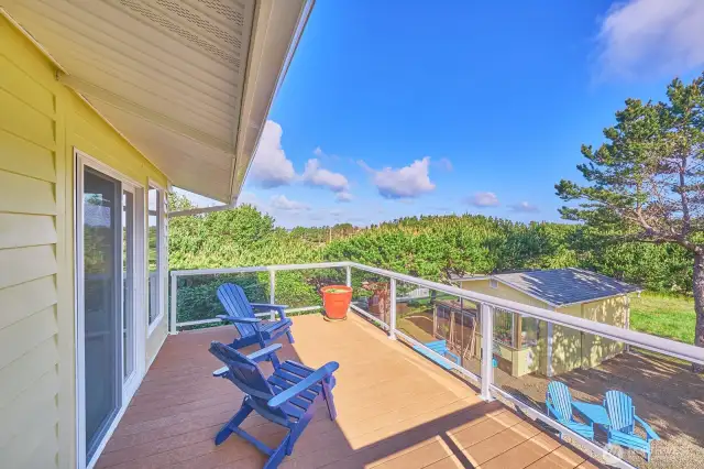 Upstairs entry deck with a view of the ocean over the surf pines.