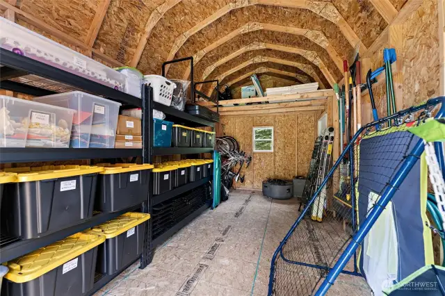 Large shed with shelving provides extra storage