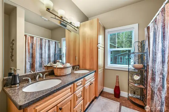 The main house bathroom also has double sinks and granite countertops.  Notice the extra cabinets - Great towel storage.