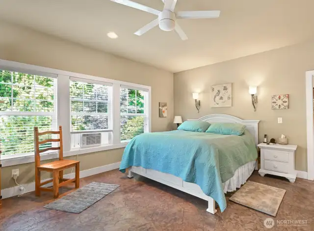 The Primary Bedroom is atthe back of the house looking out to the private grounds.  Large walk-in closet to the right .