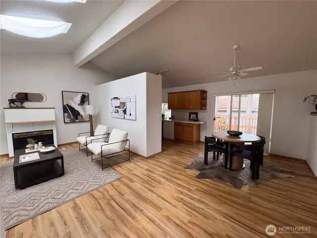 Step inside to a bright, open-concept living and dining area—designed for easy flow and everyday comfort, with a peek into the efficient galley kitchen just beyond.