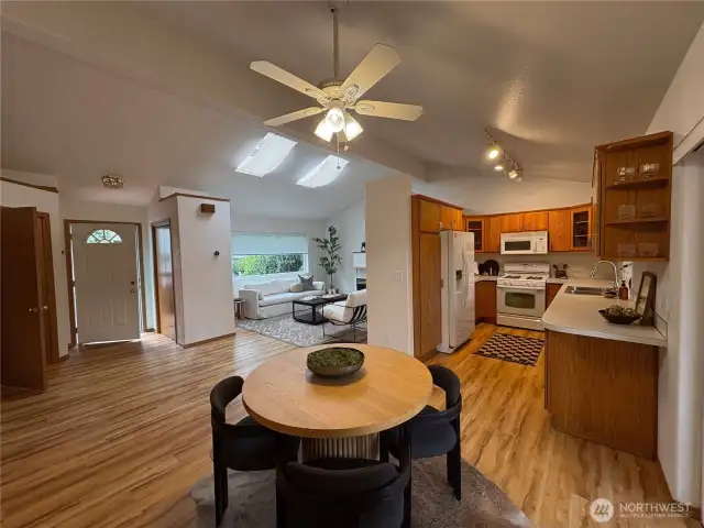 This open-concept layout brings the kitchen, dining, living, and entry spaces together seamlessly—offering a welcoming flow that’s ideal for everyday living and entertaining alike.