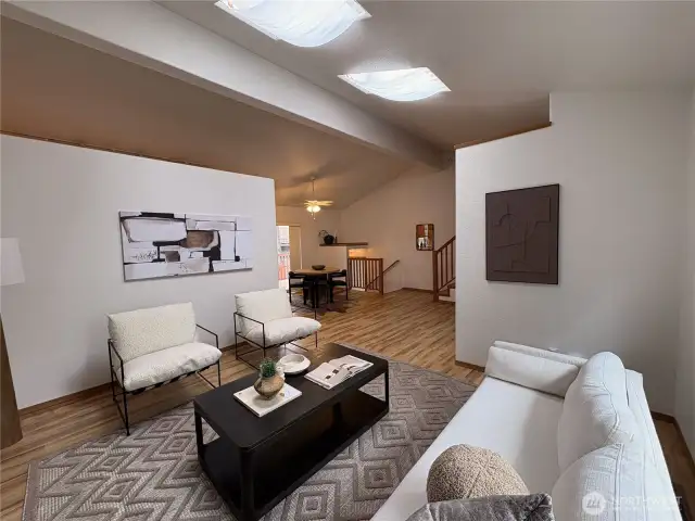 From the living room, enjoy a view back into the dining area and the unique split staircase—leading up to the private bedrooms and down to the attached double garage for everyday convenience.