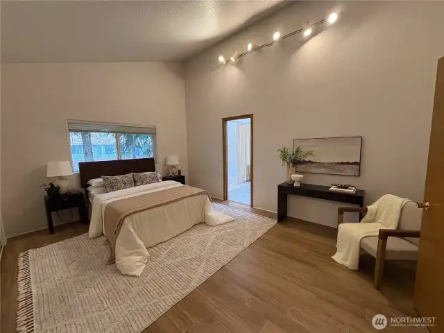 The expansive primary bedroom offers plenty of space to unwind, with the en suite bathroom just off to the side for added privacy and comfort.